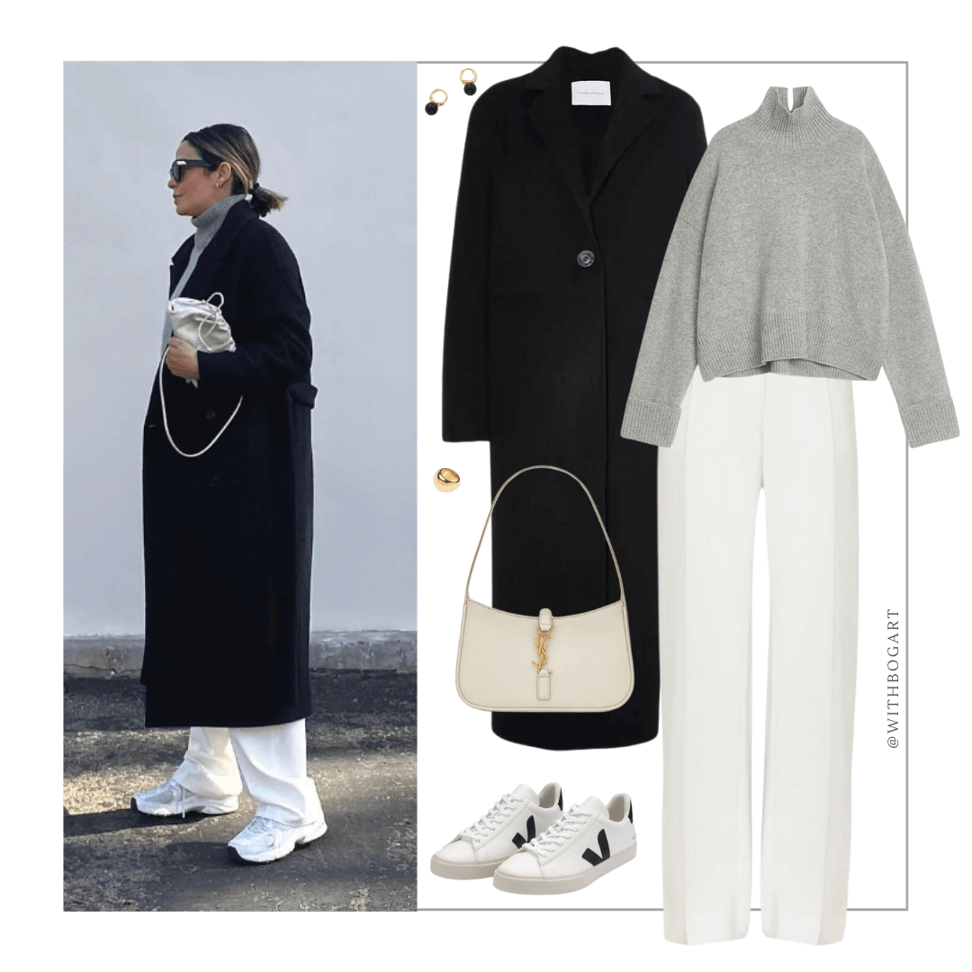 Woman wearing black coat, grey jumper, white pants, and sneakers